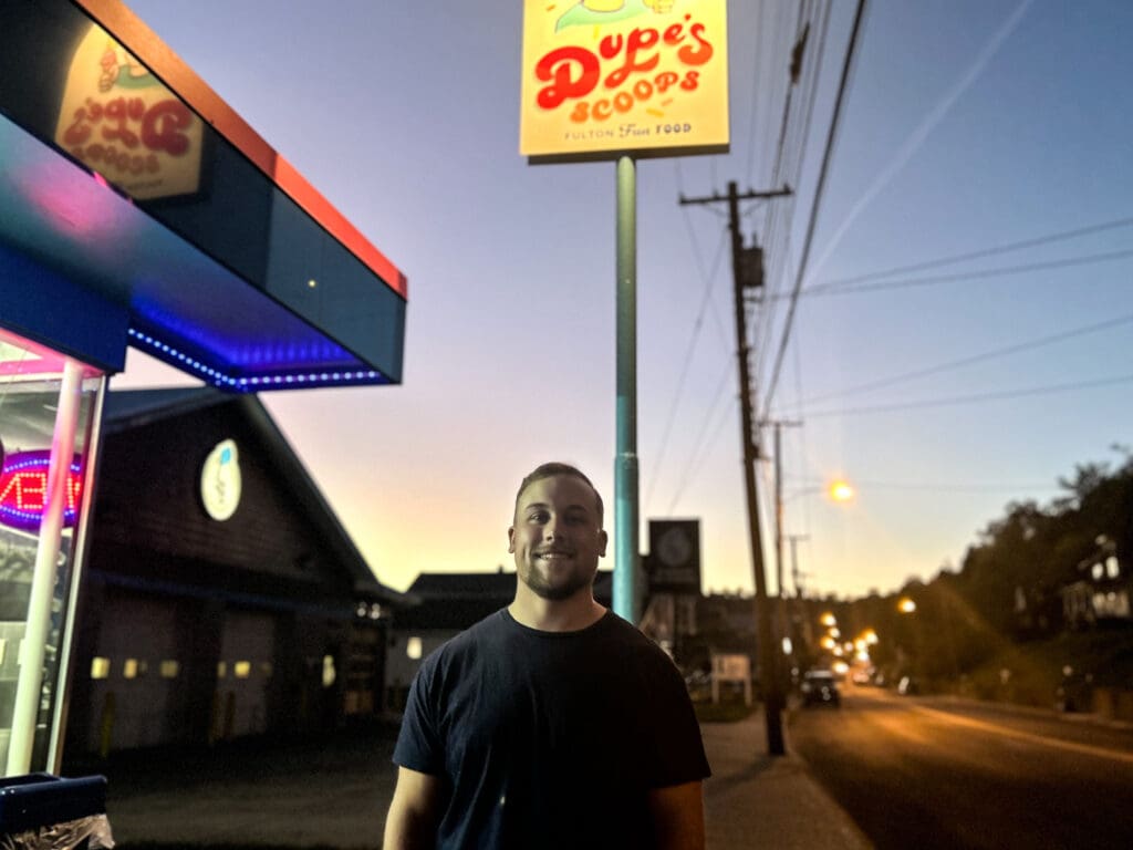 A man in front of a sign.