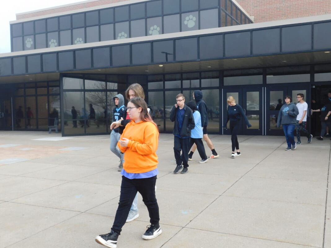 People walking out of a building.