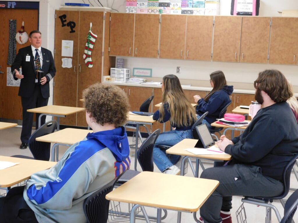 Students are sitting at a desk.