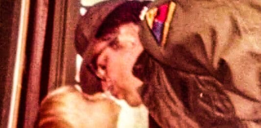 A man kissing his daughter.