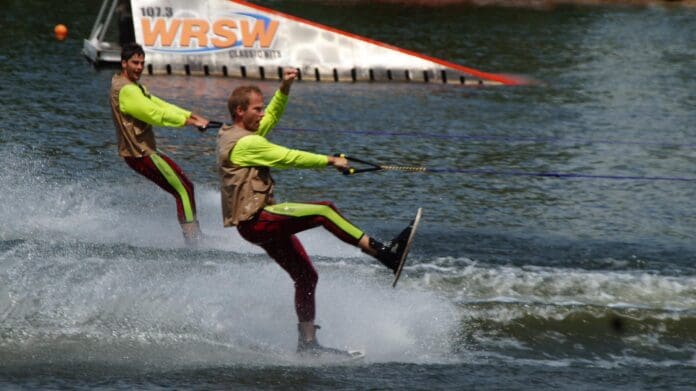 Two skiiers with a ramp in the background