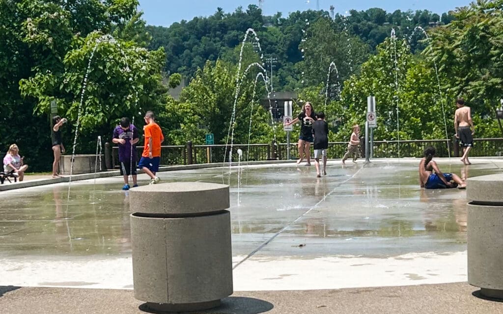 People playing in a water fountain.