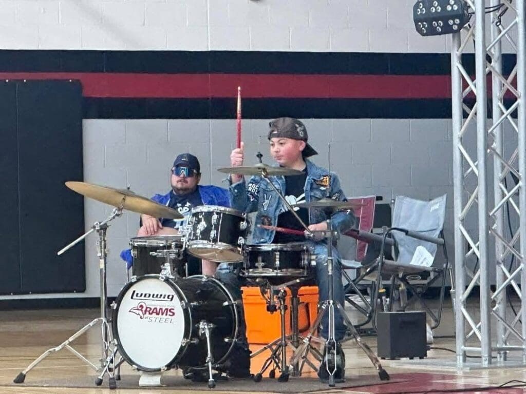 A kid playing drums.