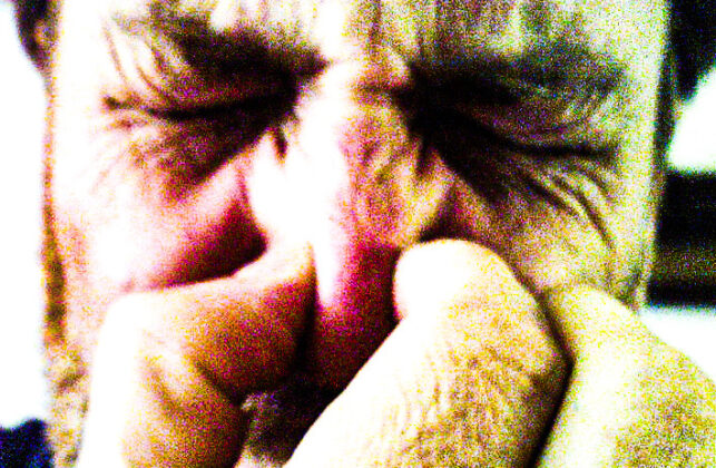 A man holding his nose.