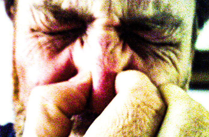 A man holding his nose.