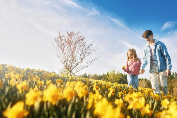 A kid with flowers.