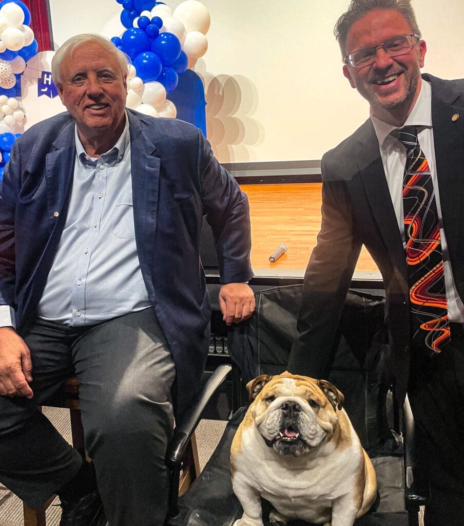 Two people with a dog.