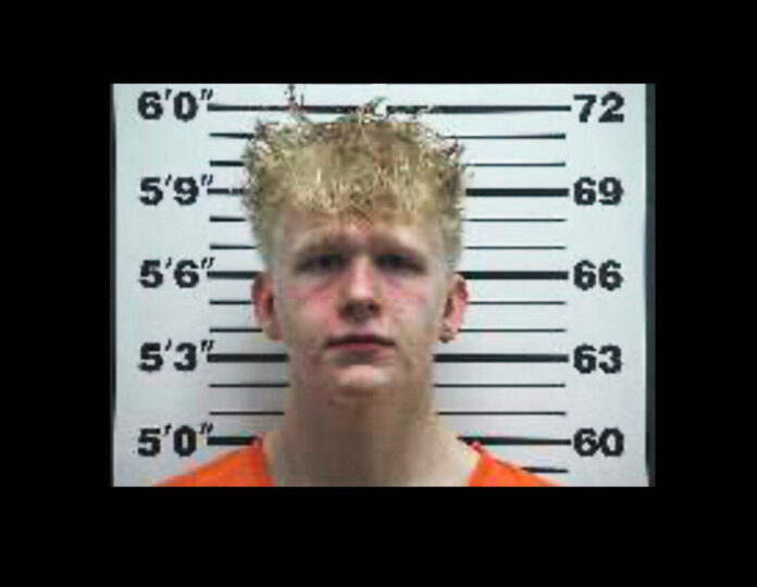 A boy in a mug shot.