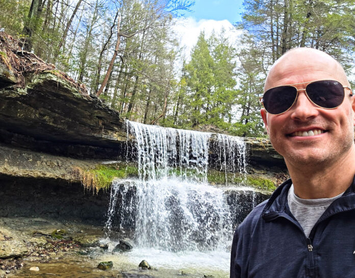 A man near a waterfall.