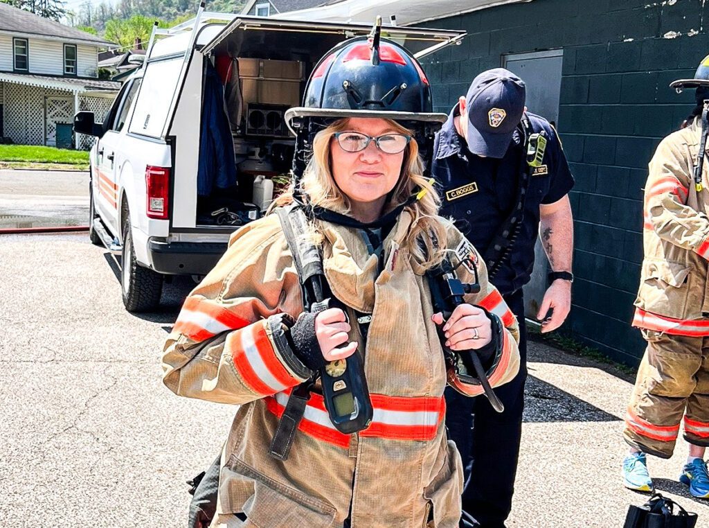 A woman in fireman's gear.