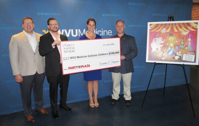 People holding a bigh check.