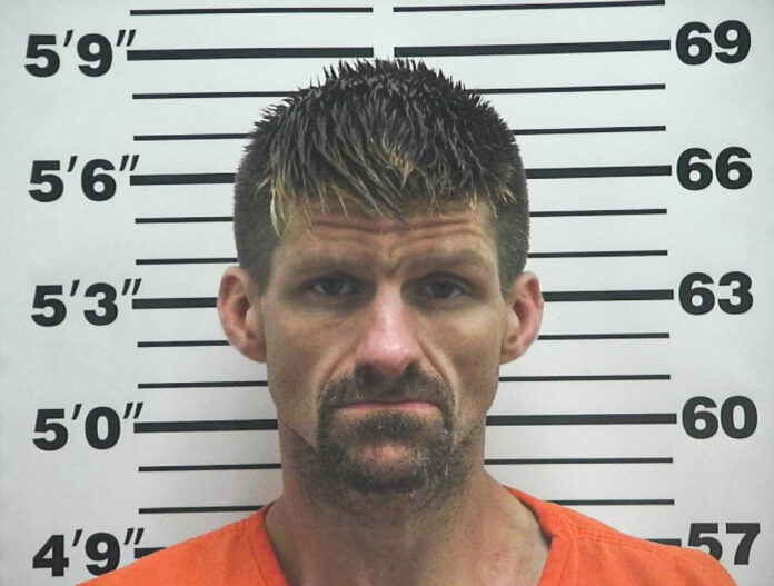 A man in a mugshot.