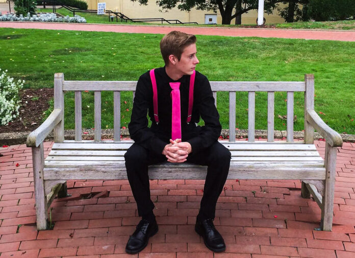 A kid on a bench.