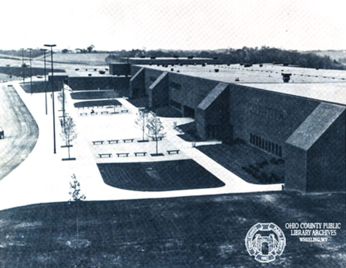 A black and white photo of a long building.