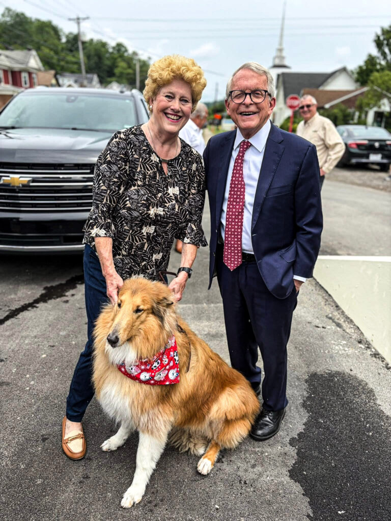 Two people and a dog.